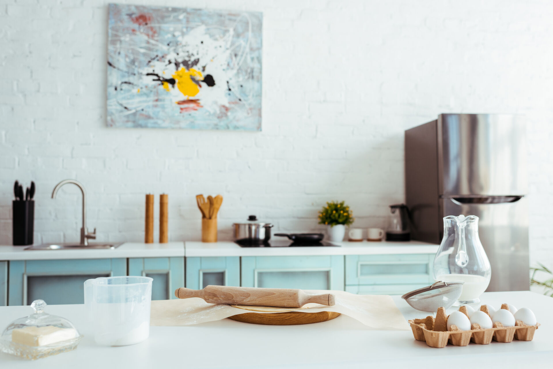 interior of light modern kitchen with bakery ingredients on table
