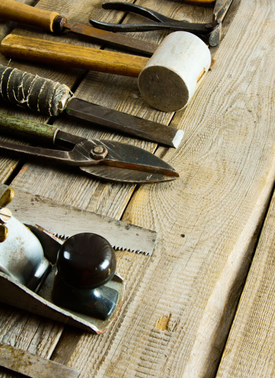 Old working tools. Various tools on a wooden background.
